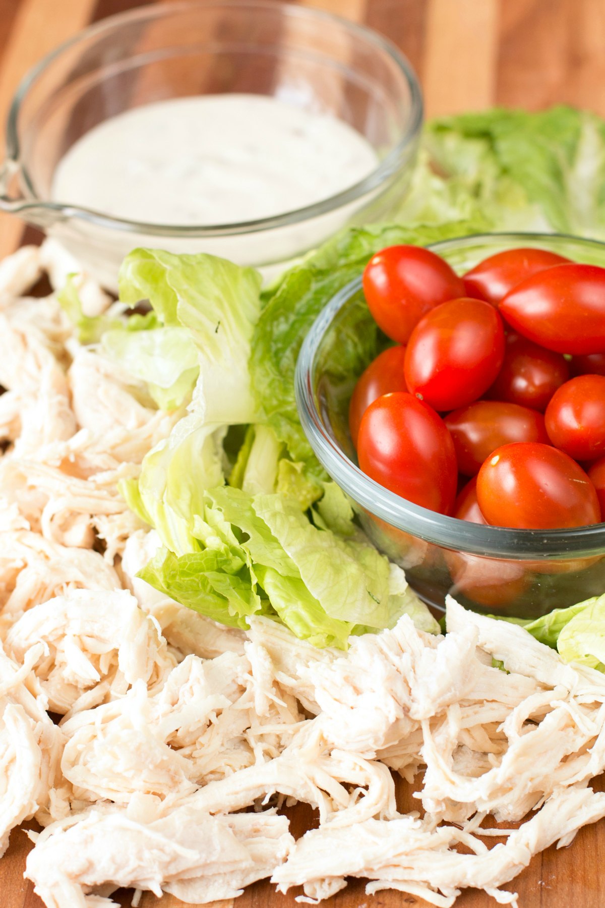 Chicken Caesar Wrap Ingredients on a cutting board