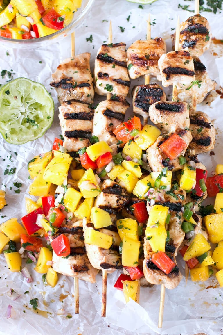 Easy Grilled Mango Chicken Skewers with a fresh mango and pepper salsa are deliciously juicy and packed with flavor. These are great for dinner! #grilledchicken #chicken #mango #chickenkabob
