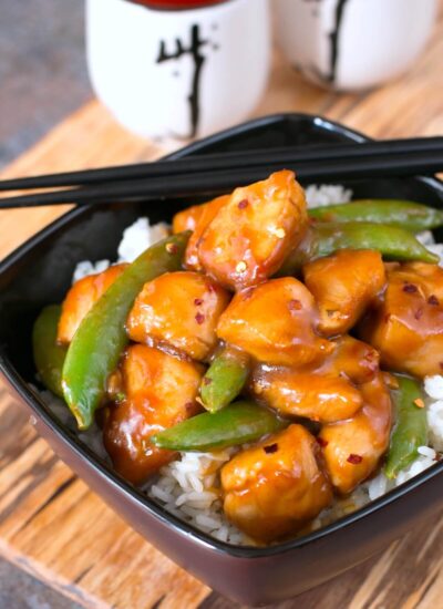 easy orange chicken in a black bowl.