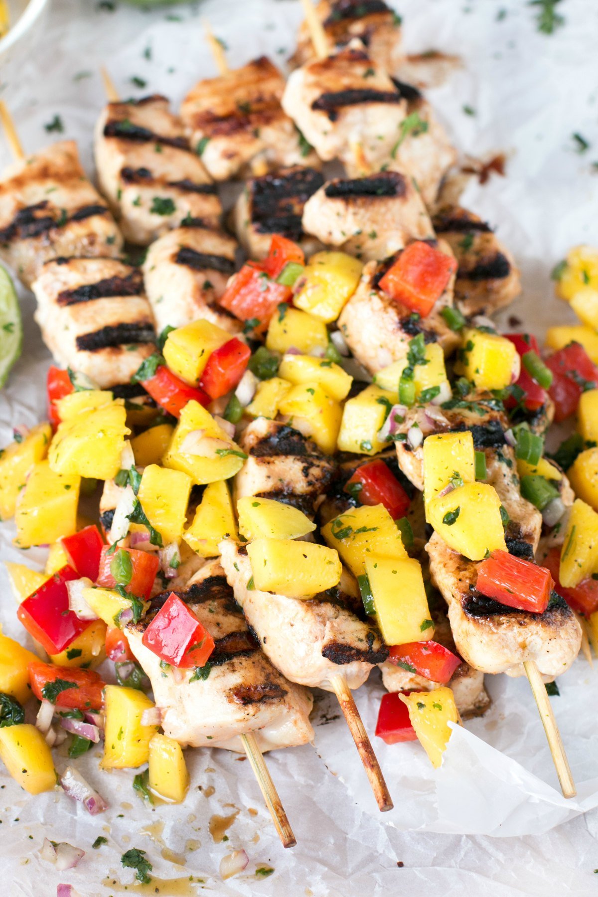 Stacked mango chicken skewers with mango and bell pepper salsa