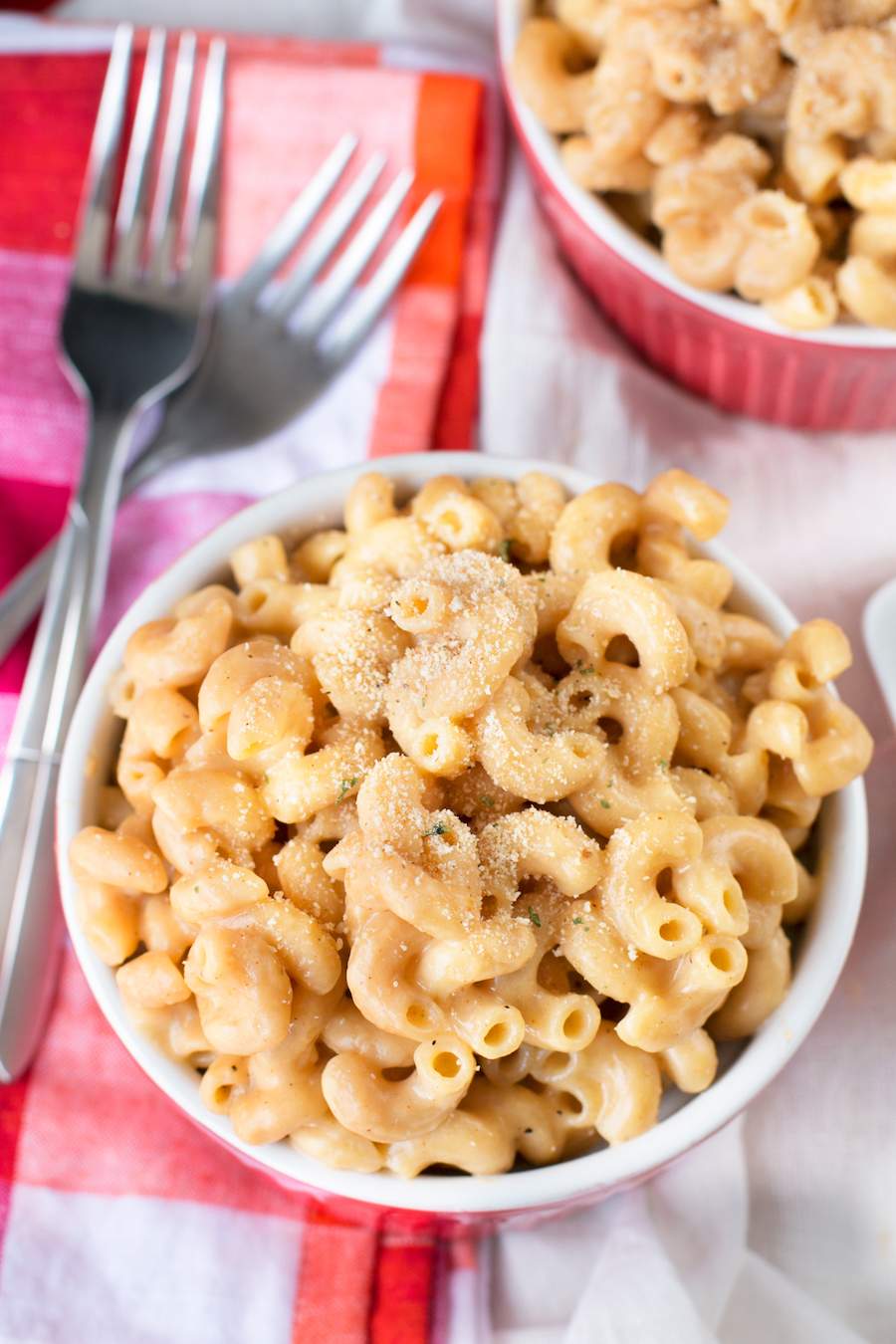 Top down photo of One Pot Whole Wheat Macaroni and Cheese in a ramekin with forks to the left.