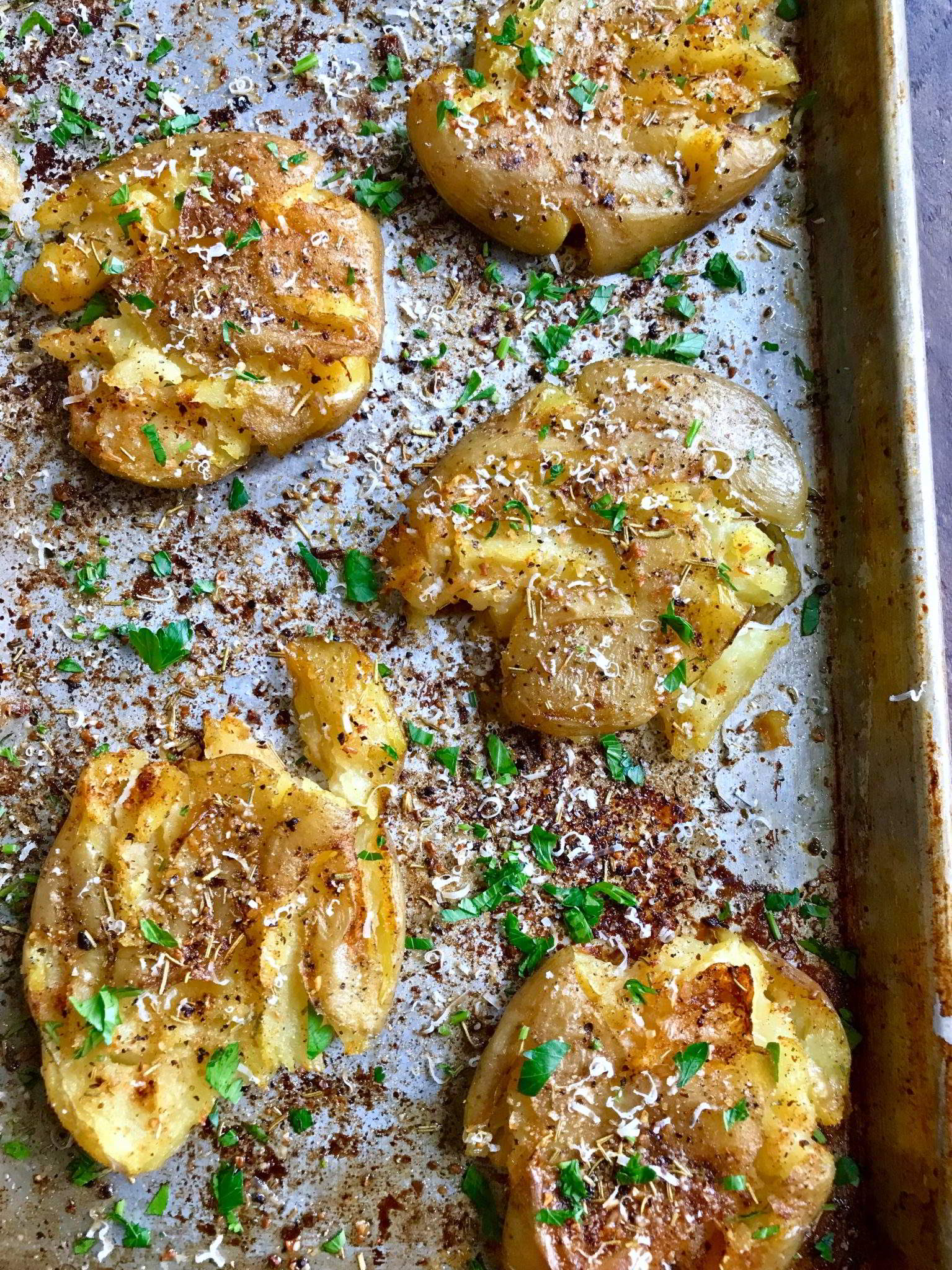Parmesan Herbed Potatoes on a baking tray