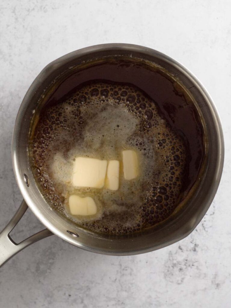 Butter added to caramelized sugar.