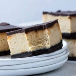 Chocolate Peanut Butter Cheesecake Bar on a plate with a bite taken out of it.