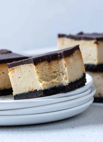 Chocolate Peanut Butter Cheesecake Bar on a plate with a bite taken out of it.