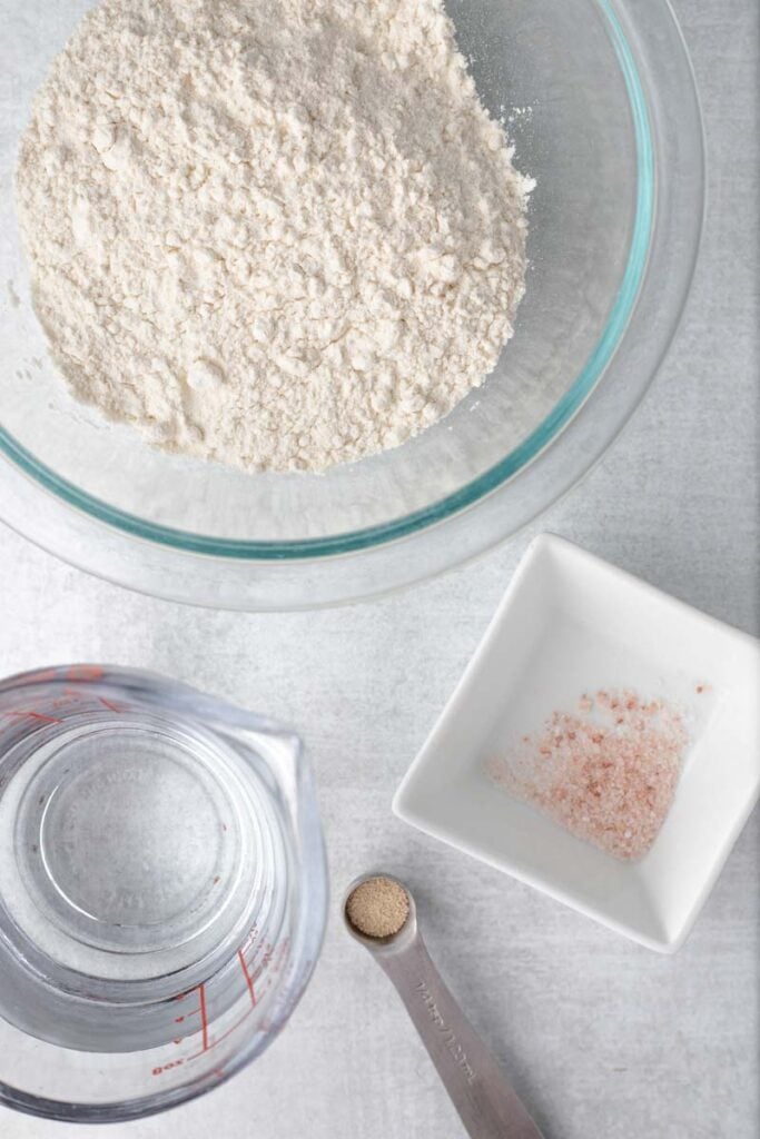 Overhead view of flour, water, yeast, and salt.