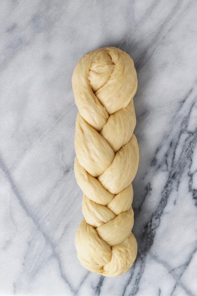 Braided challah bread before being baked