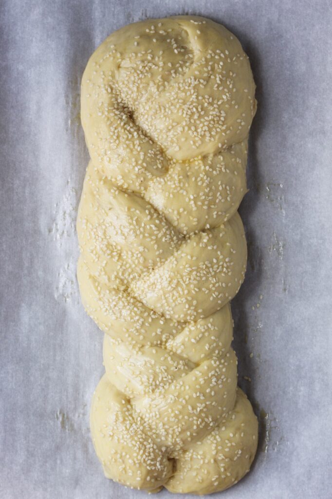 Egg wash and sesame seeds sprinkled on top of bread before baking.