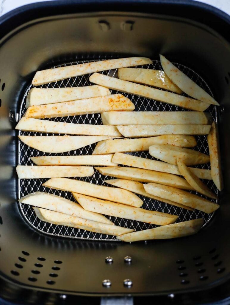 Top down shot of sweet potato slices in the air fryer.