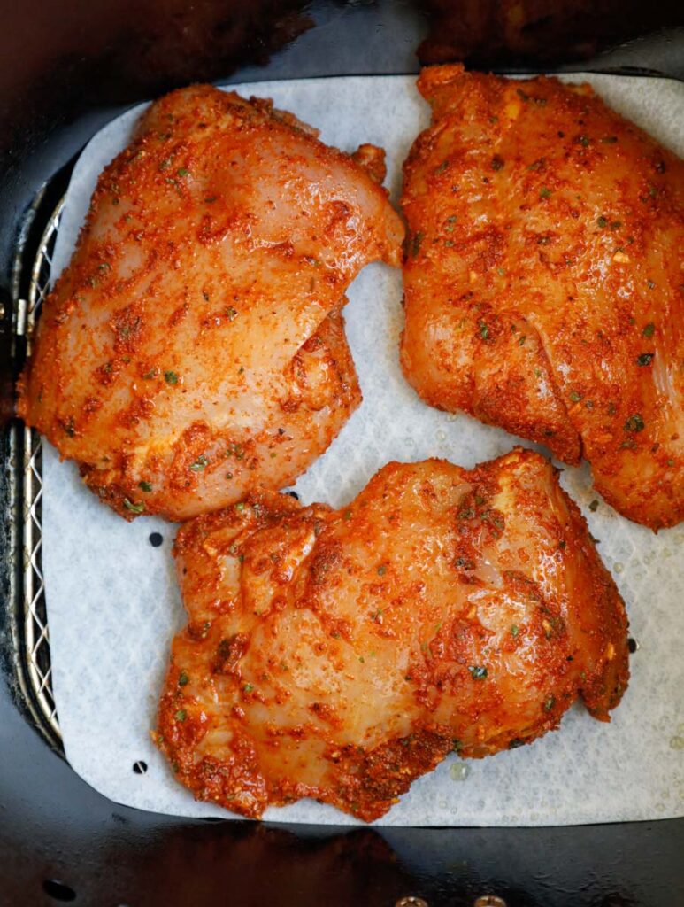 Raw chicken in an air fryer.