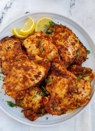 Overhead shot of air fryer boneless chicken thighs on a plate.