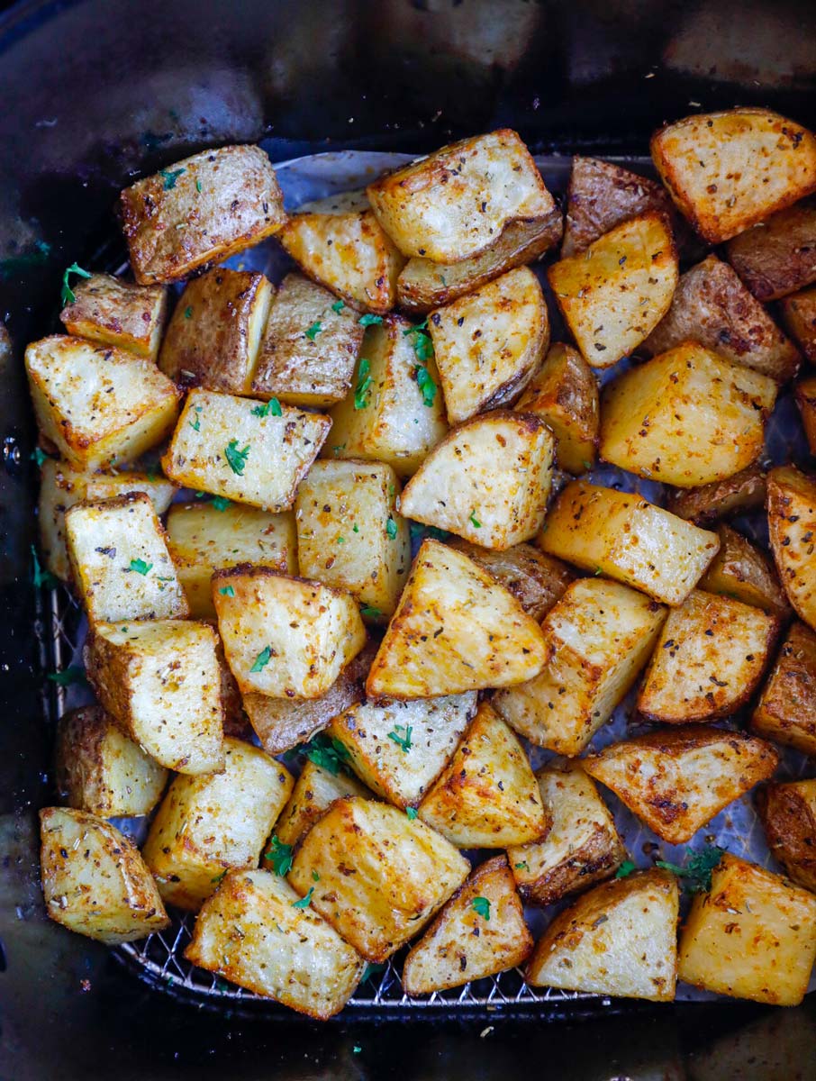 Potatoes inside of an air fryer basket.