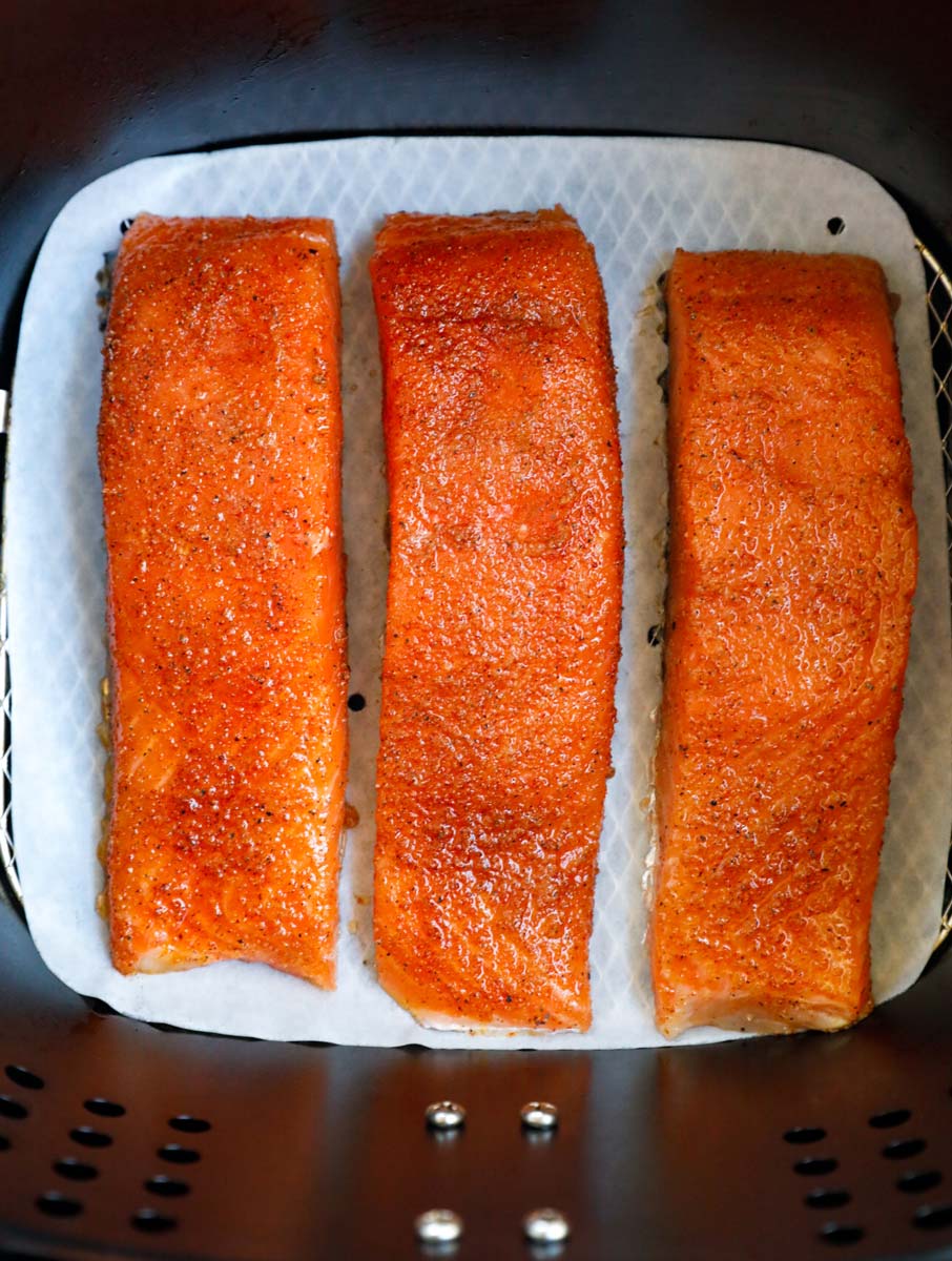 Raw salmon fillets in an air fryer.