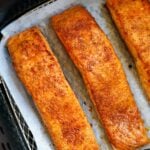 Cooked salmon fillets in an air fryer.