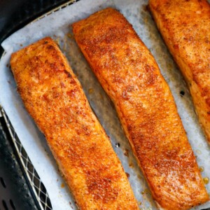 Cooked salmon fillets in an air fryer.