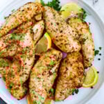 Top down view of lemon pepper chicken on a plate.