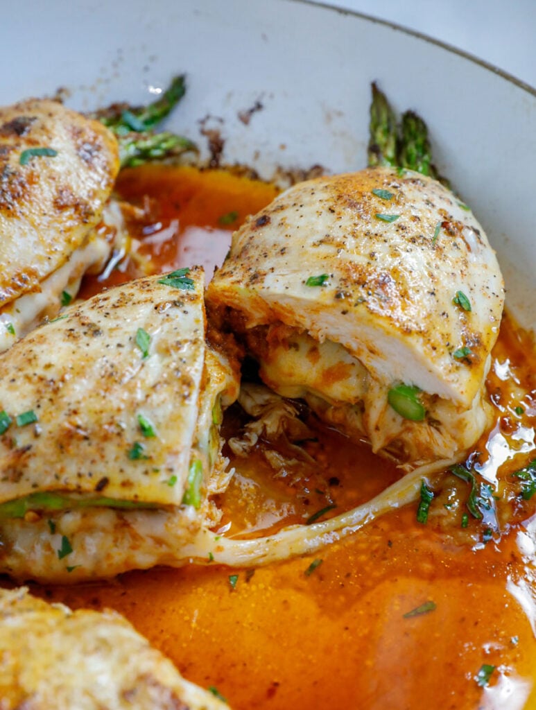 Asparagus stuffed chicken cut n half. 