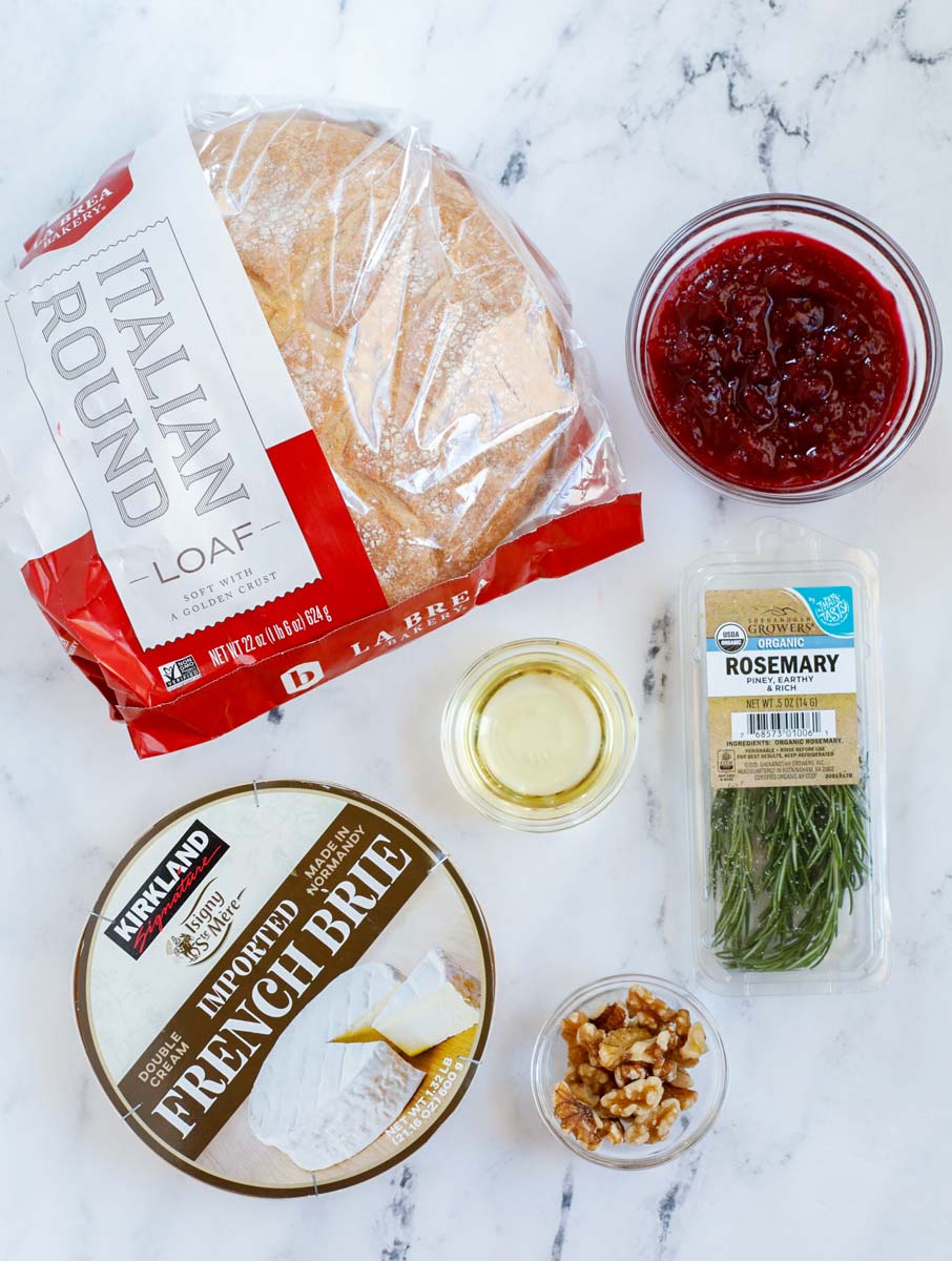 Top down view of ingredients for baked brie bread board.