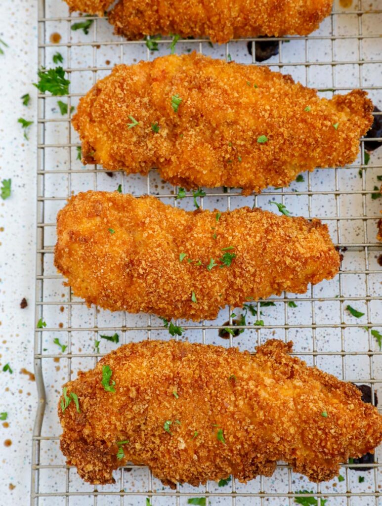 Top down shot of chicken tenders on a wire rack.