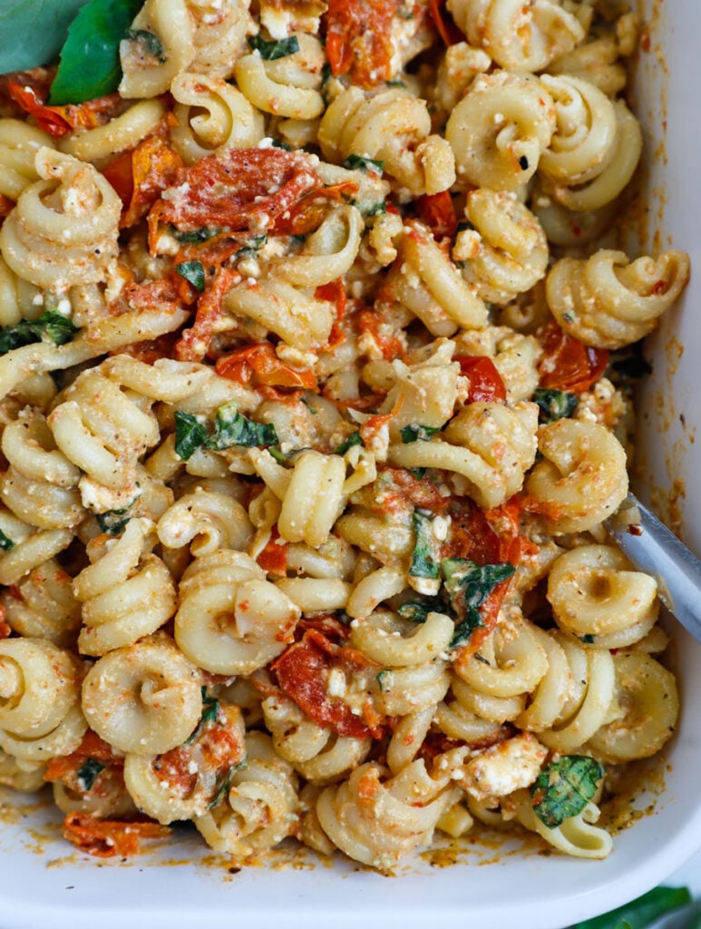 Close up of a baked feta pasta in a baking dish.