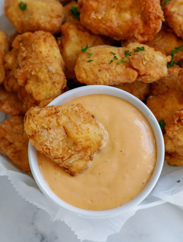 chicken nuggets dipped in sauce