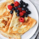 crepes and berries served on a plate