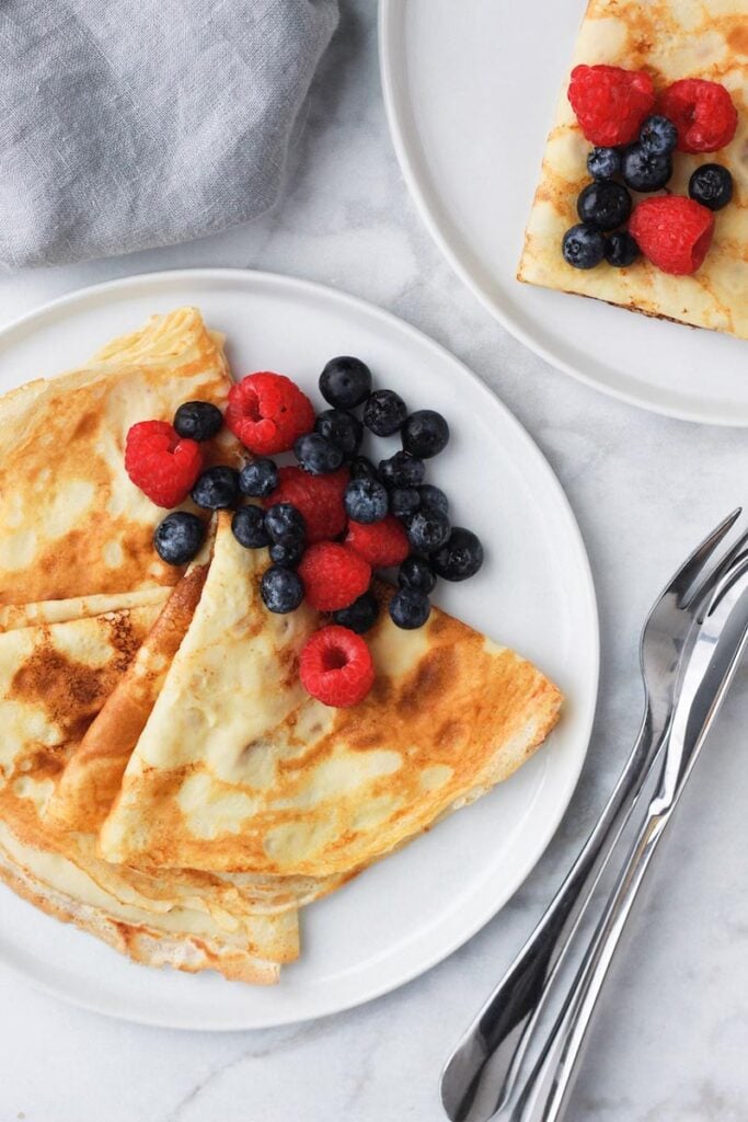 Crepes on a plate with berries.