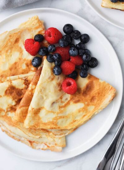 crepes and berries served on a plate