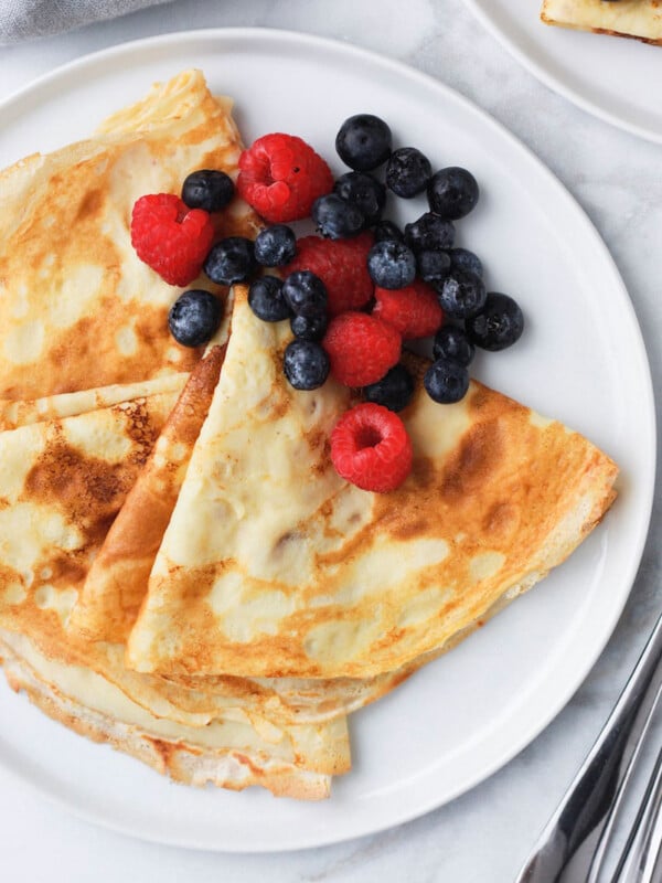 crepes and berries served on a plate