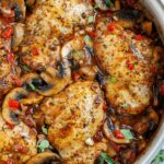 Top down shot of tuscan chicken in a pot.