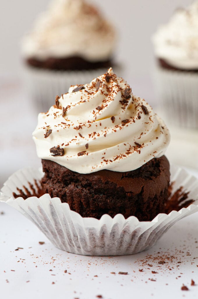 chocolate cupcake with the wrap being taken off half way