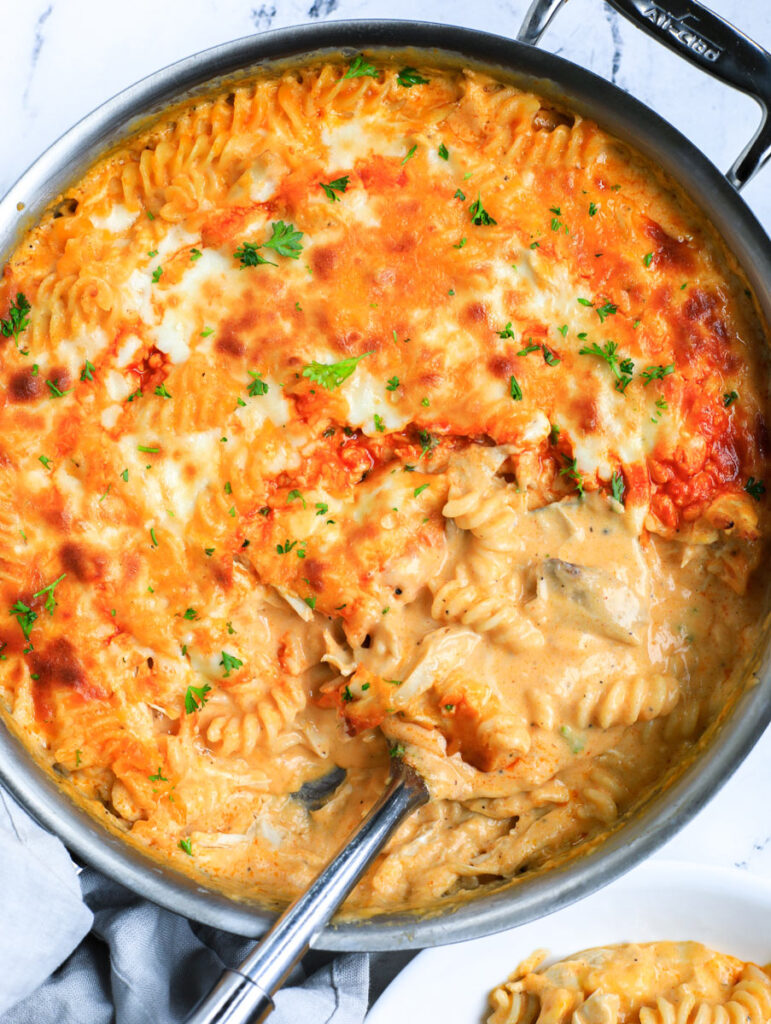 Top down view of the mac and cheese with a spoon in the skillet.