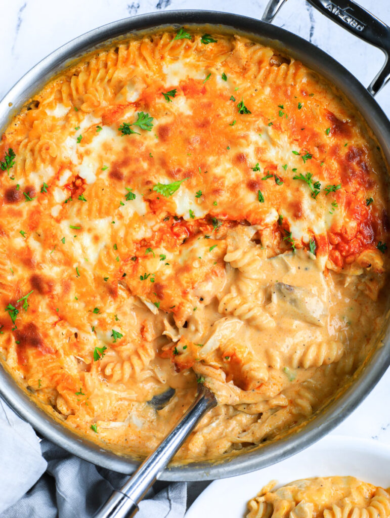 Top down view of the mac and cheese with a spoon in the skillet. 