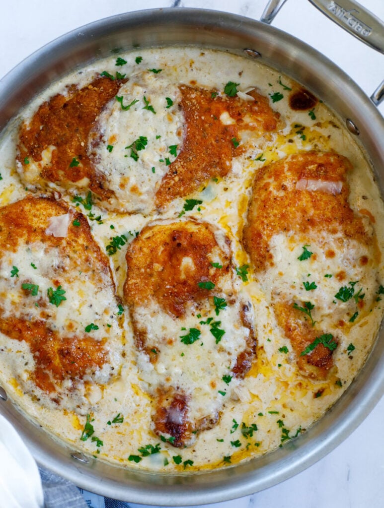 Chicken in a creamy sauce in a skillet.