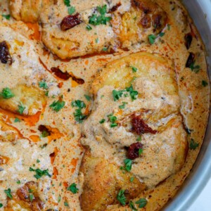 Close up of a chicken breast in cajun sauce.