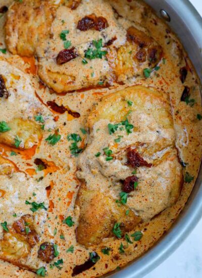 Close up of a chicken breast in cajun sauce.