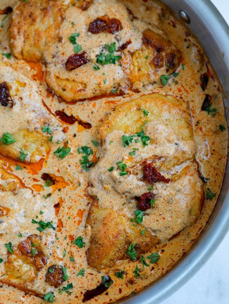 Close up of a chicken breast in cajun sauce.