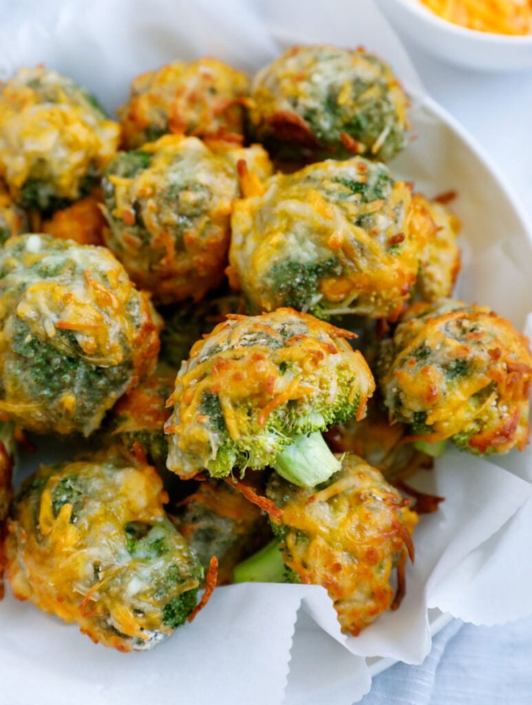 Close up of cheesy broccoli bites in a bowl.