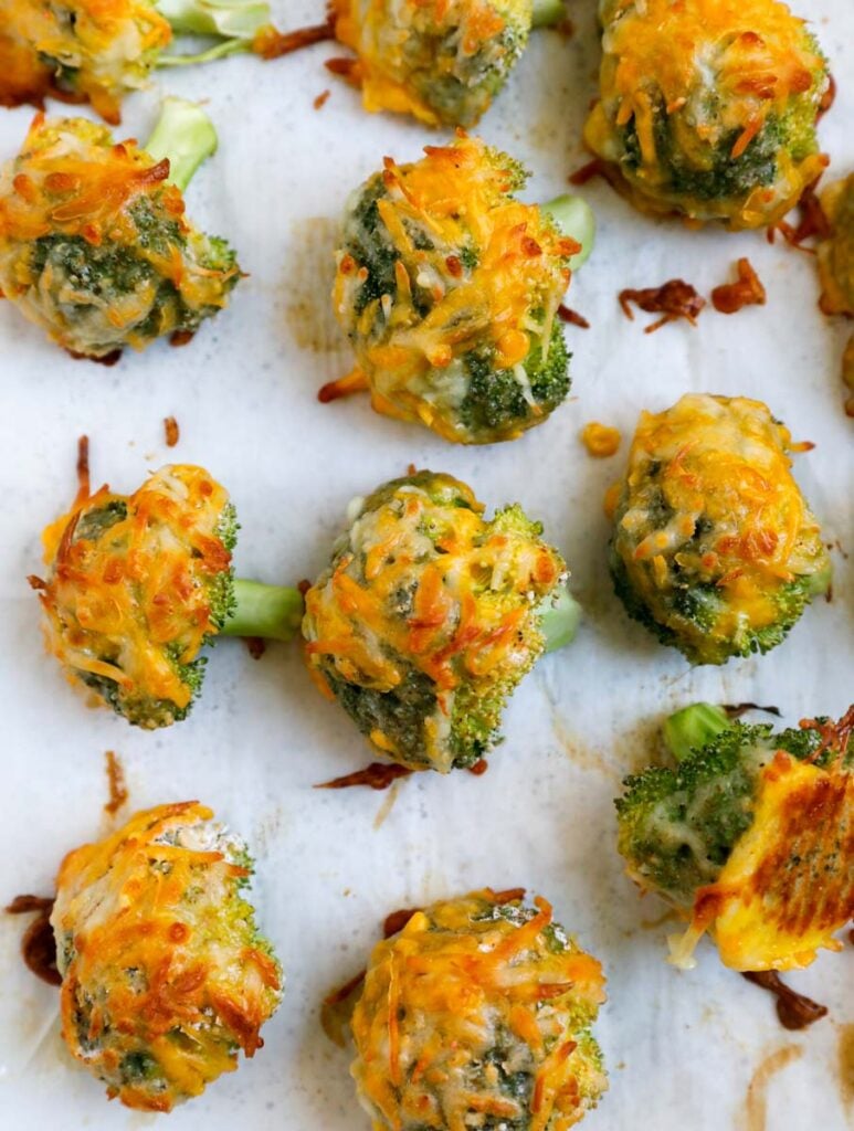 Cheesy broccoli bites on a baking sheet.