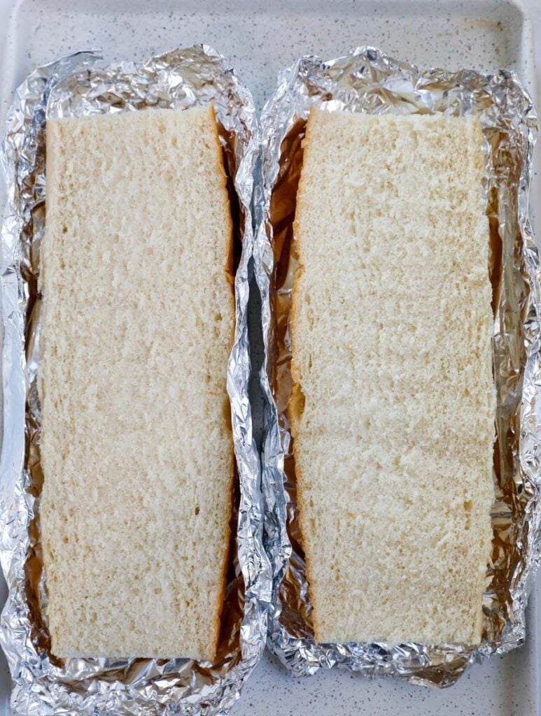 Top down shot of sliced bread in foil.