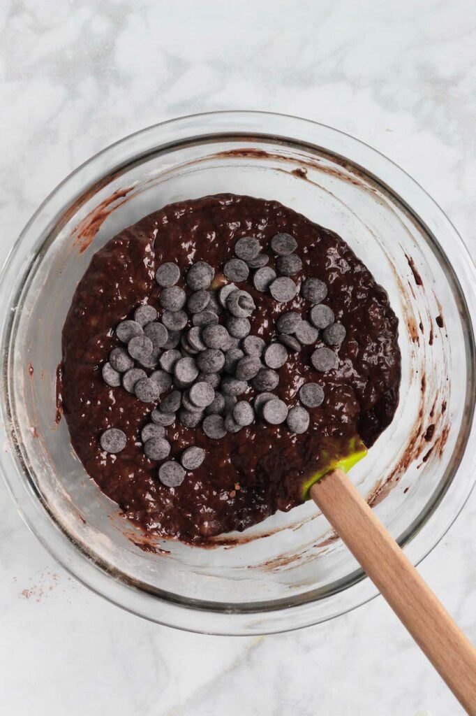 chocolate banana bread ingredients in a bowl after mixing with chocolate chips on top