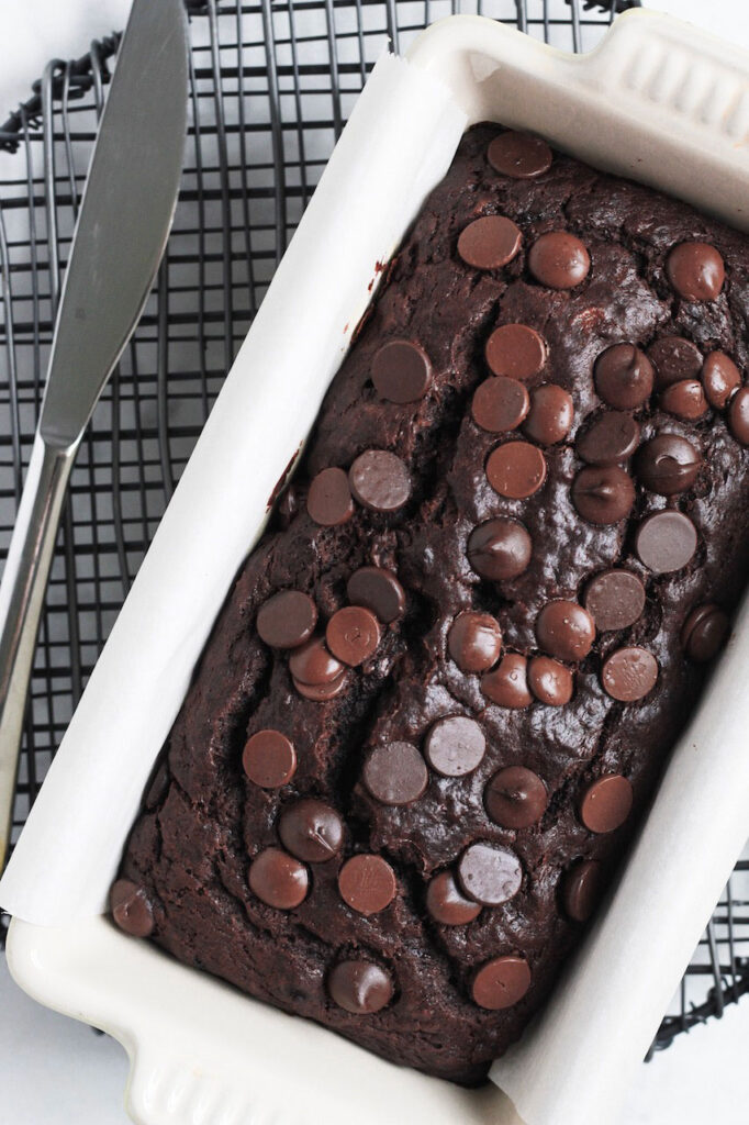 Top down shot of chocolate banana bread in a white loaf pan.