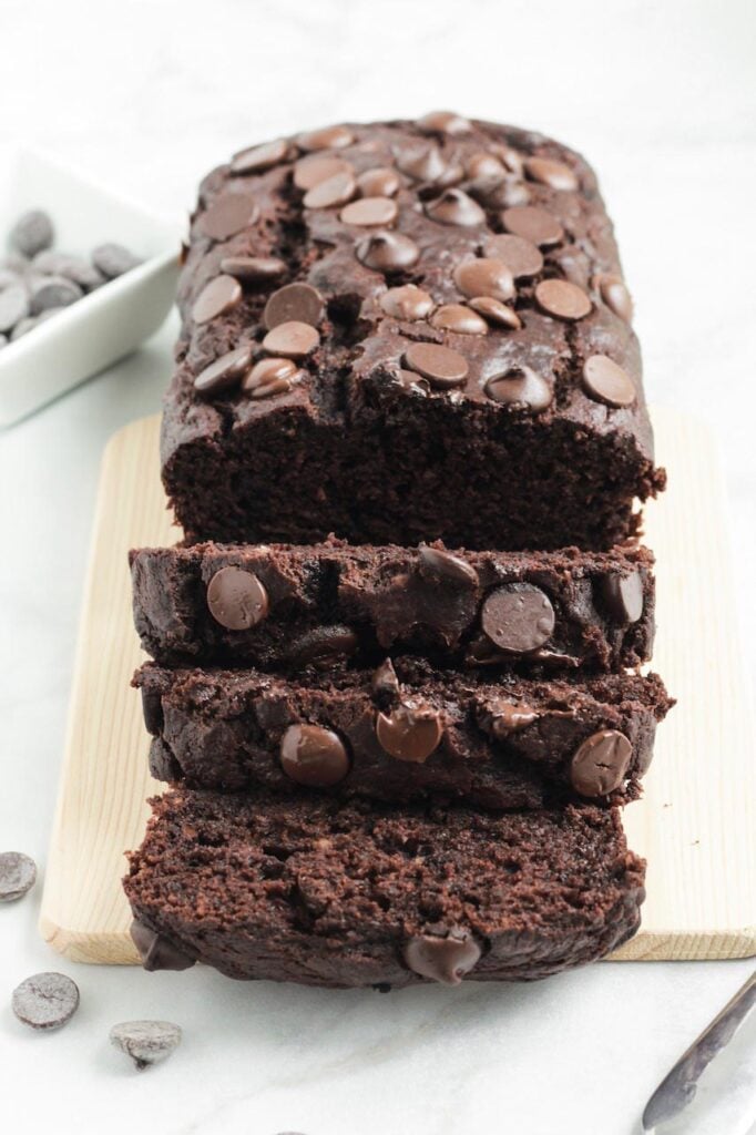 Shot of sliced chocolate banana bread on a wooden board.