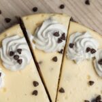 top down view of chocolate chip cheesecake with a slice cut out