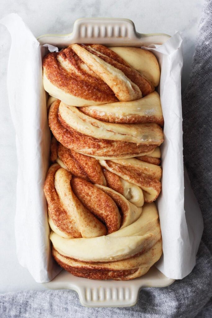 Top down shot of cinnamon babka in a loaf pan.