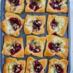 Top down shot of cranberry brie bites in a pan.