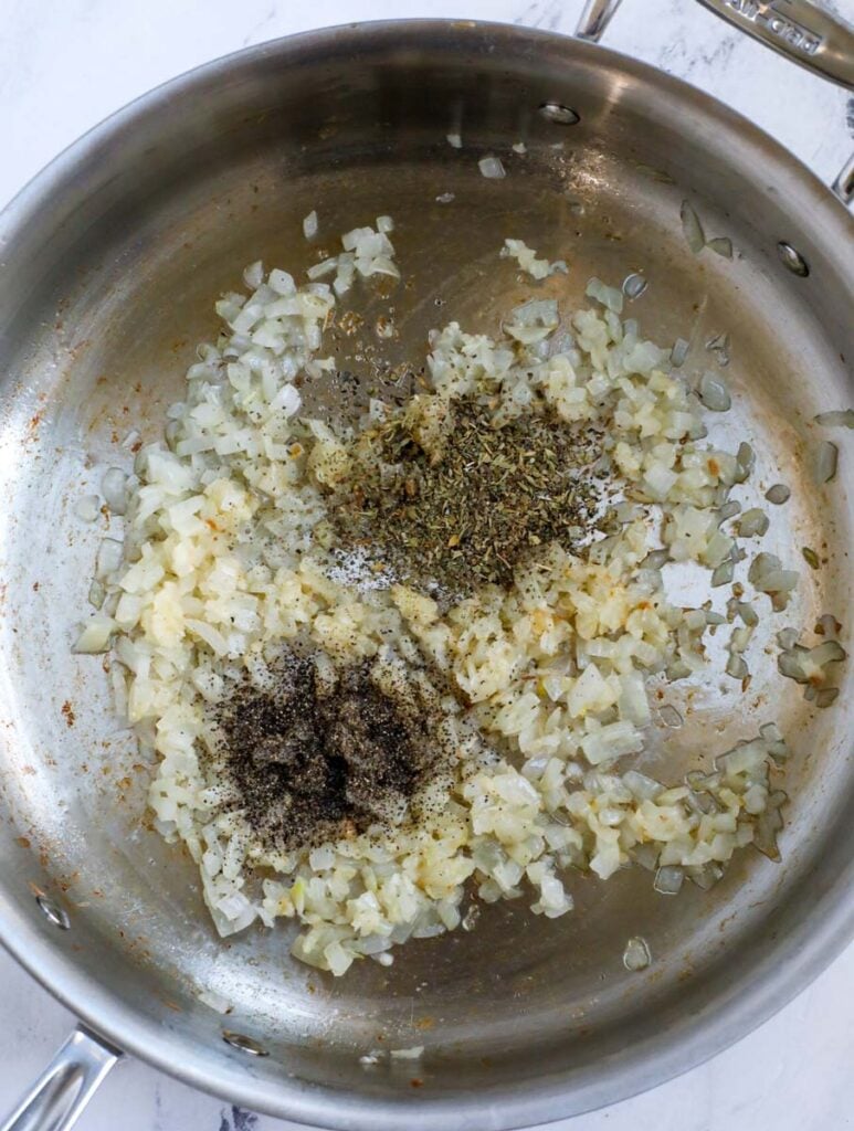 Cooking onions and garlic in a pan.