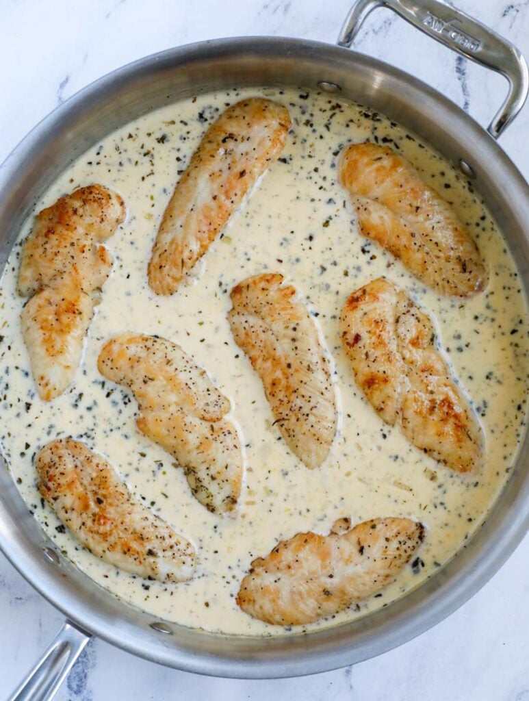 Chicken tenders in a pan, in a cream sauce. 