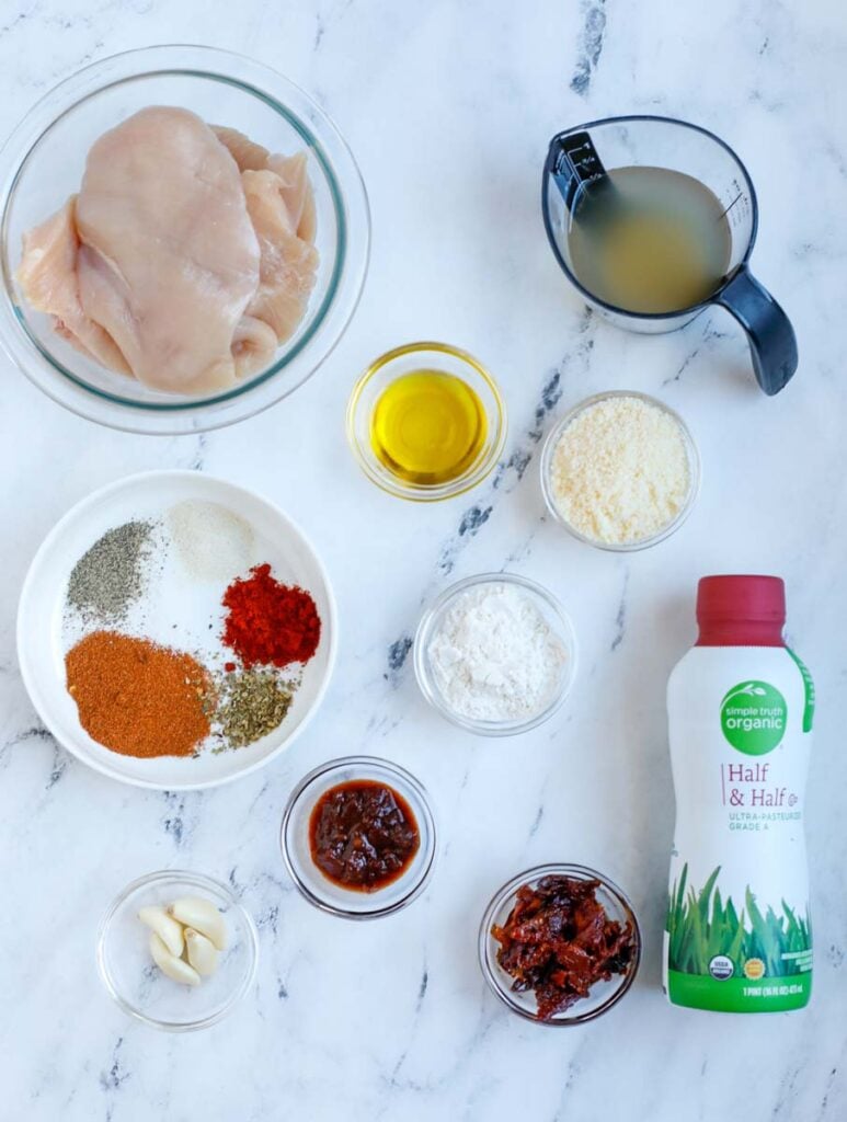 Overhead image of ingredients needed to make creamy cajun chicken in a skillet.