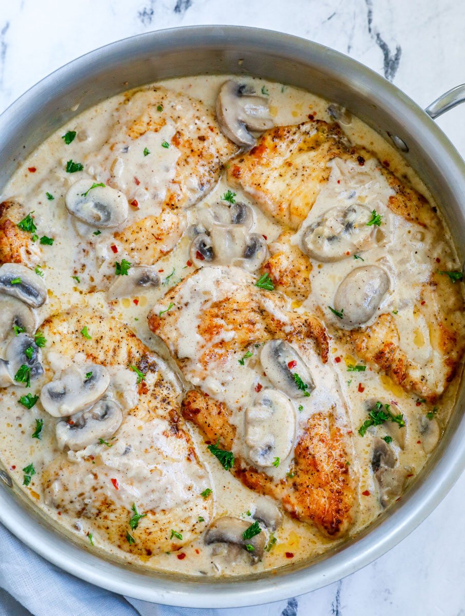 Top down shot of creamy mushroom chicken in a pot.